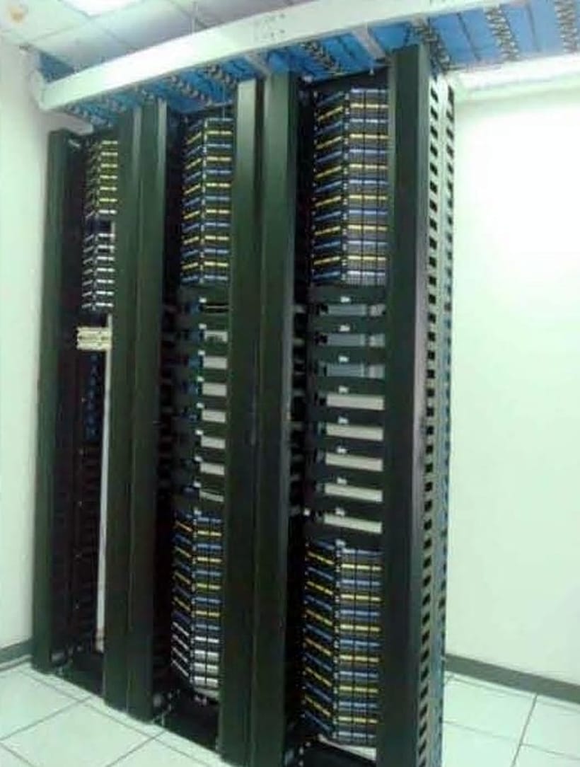 Row of floor-standing data cabinets installed in a client server room
