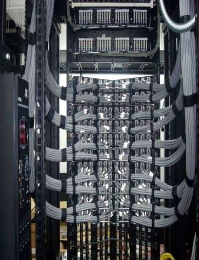 Patch panels and grey voice cross-connects dressed down a vertical manager
